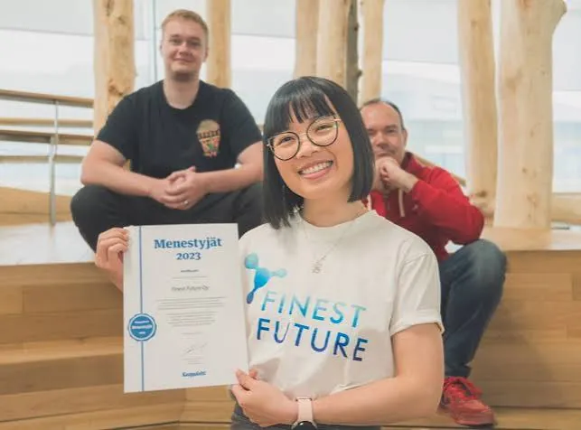 Finest Future team members holding the Menestyjät 2023 certificate
